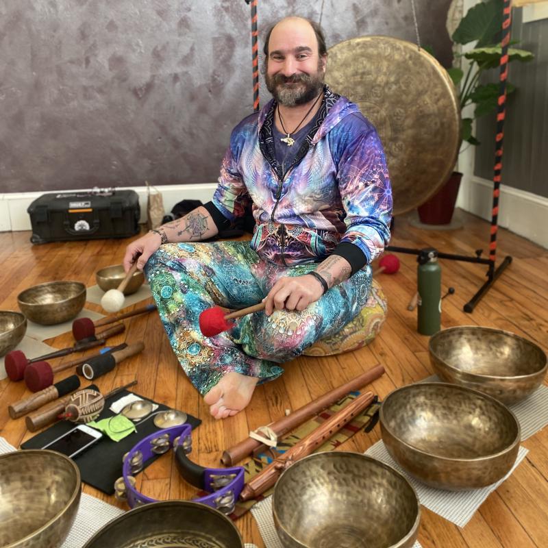 Christian surrounded by singing bowls