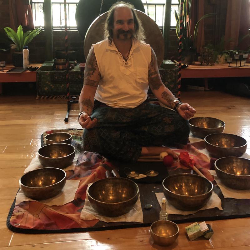 Christian surrounded by singing bowls
