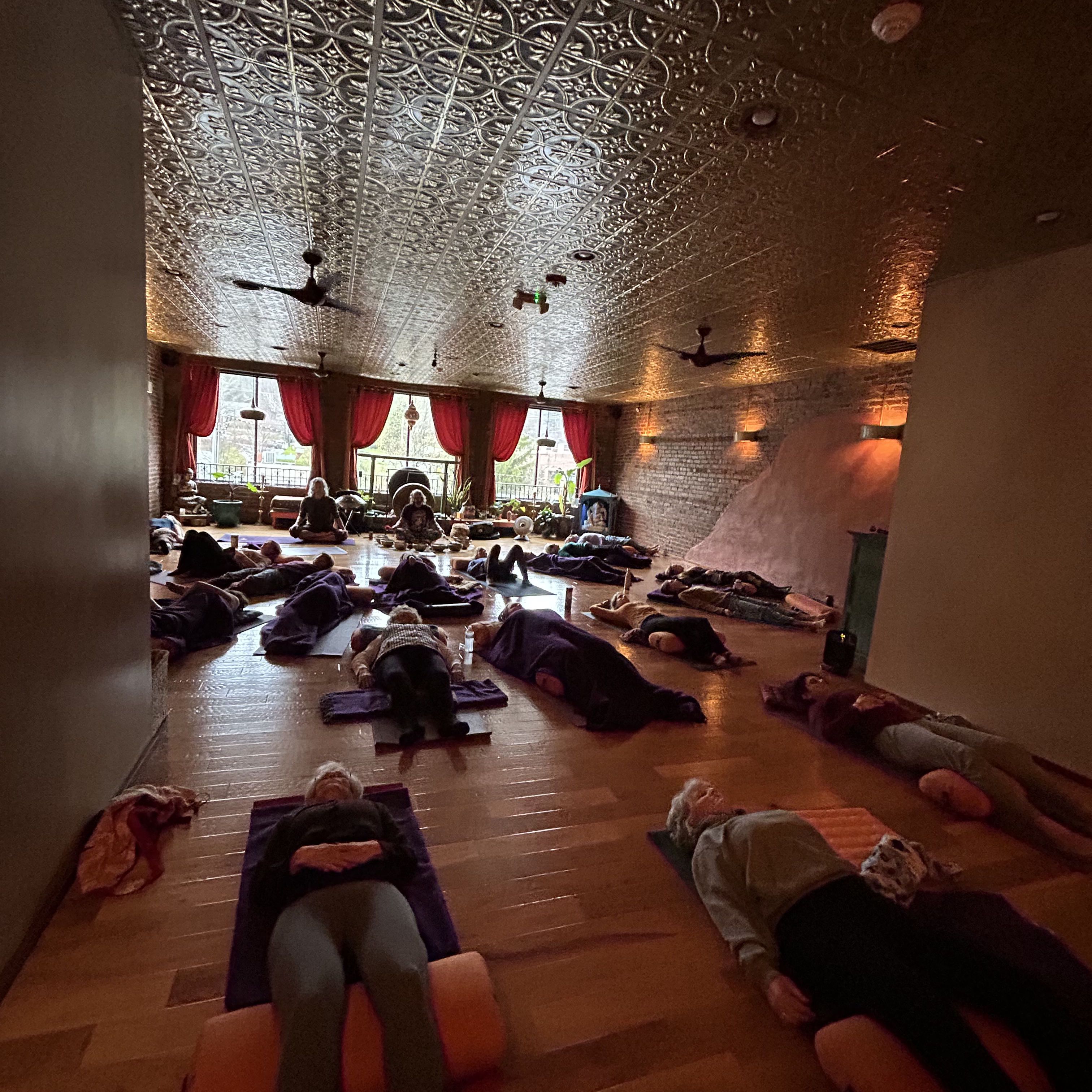 sound bath group resting under golden ceiling